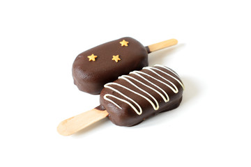 Two ice cream on a stick coated with chocolate. Isolated on a white background.