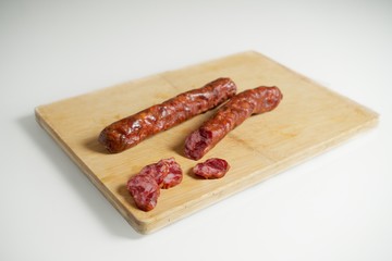 Smoked sausage on a wooden board, pork sausage, Bavarian specialty.