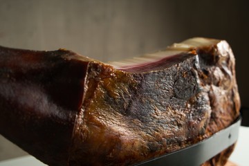 Smoked pork leg on the table, prosciutto, jamon, Iberian pork