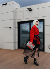 Girl model in a stylish bow. Black and red clothes, street style fashion.