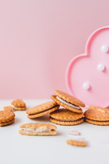 Sweet creamy filling crackers on a white-pink pastel background. 