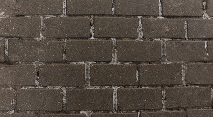 Gray paving stones on the square in the Park.Sidewalk, driveway, sidewalk, 
floor covering square pattern background texture.