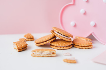Sweet creamy filling crackers on a white-pink pastel background. 