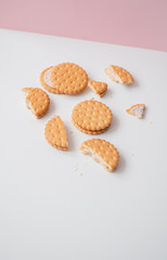 Sweet creamy filling crackers on a white-pink pastel background. 