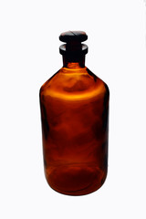 Old retro big bottle brown glass with glass askew plug on a white background front view