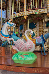 Colorful merry-go-round with animal figures. Empty vintage carousel in park. Retro roundabout. Fairground carousel.Childhood concept. Summertime fun. Festival carnival. Outdoor circus concept. © Nataliia