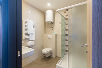 View to a bathroom interior with glass shower cabin