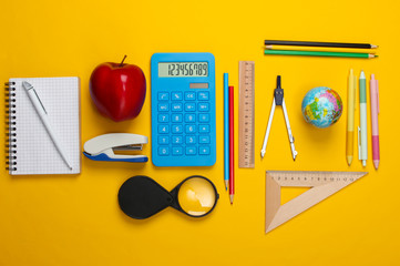 Back to school. School and office supplies on yellow background. Educational, study concept. Top view.