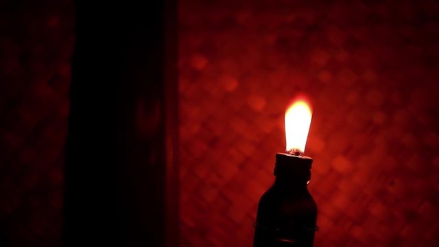 Traditional oil lamp illuminates a room in a rural house. A concept of a rustic night atmosphere or no electricity. Suitable for background of videos about peace or poetry or village.