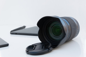 Photographic lens with graphic tablet on white background. Technology concept.