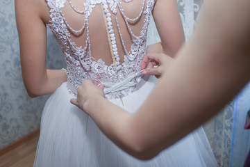 bride holding a wedding dress