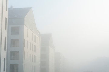 Modern apartment buildings in a foggy morning