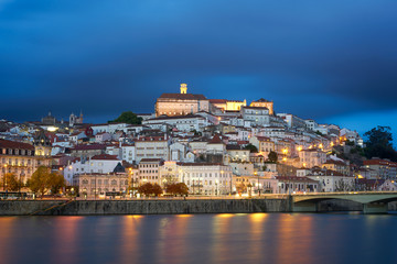 Coimbra city view at night with Mondego river and beautiful historic buildings, in Portugal