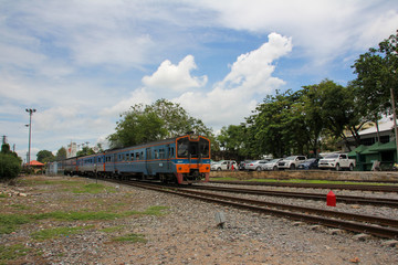 Fototapeta na wymiar Blue and orange train arriving at Lopburi