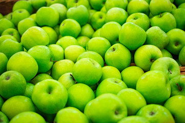 green golden apples on the supermarket counter background
