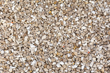 The gravels background, there are a lot of gravels that different shape and colors on the floor.