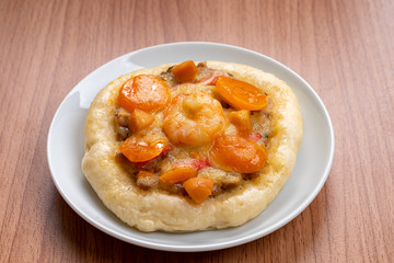 Pizza Cheese with Shrimp, Pork, Imitation Crab Stick and Salted Eggs on White Dish Wood Table.