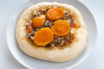 Pizza Cheese with Shrimp, Pork, Imitation Crab Stick and Salted Eggs on White Dish Wood Table.