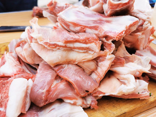 chunks of raw meat sliced and stacked before cooking close up