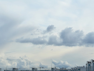 gray clouds in the sky over buildings of various shapes during the day