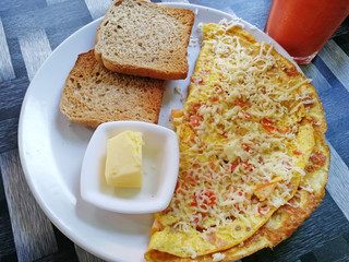 Breakfast of Spanish omelette with toast and butter on a plate