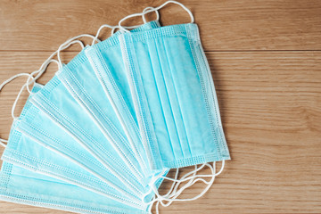 Protective face masks against the corona virus - COVID-19 on a wooden table.