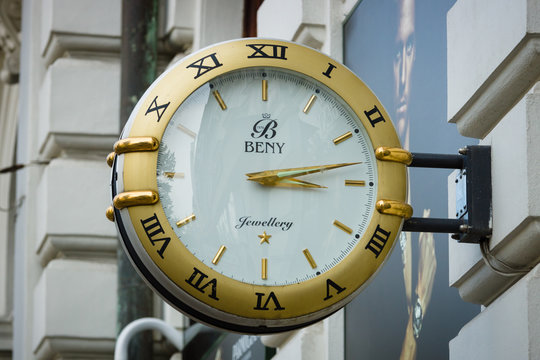 PRAGUE, CZECH REPUBLIC - SEPTEMBER 18, 2014: Signboard In The Form Of Large Wall Clocks, Shops Selling Watches, Gold Jewelry And Accessories 