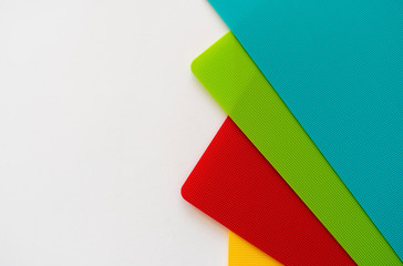 Colorful plastic sheets with tiny dots on a white background