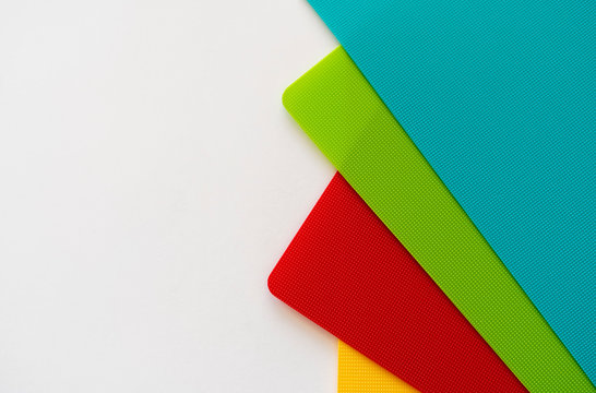 Colorful plastic sheets with tiny dots on a white background