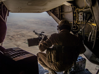 Helmand, Afghanistan - January 2013: Ramp gunner on a US MArines Osprey flying over Helmand - obrazy, fototapety, plakaty