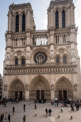 Fototapeta na wymiar Paris, France- February 2013: Exterior and entrance to Notre Dame cathedral