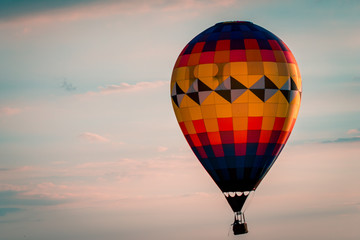 Hot air balloon floating by during a beautiful sunset during an airshow