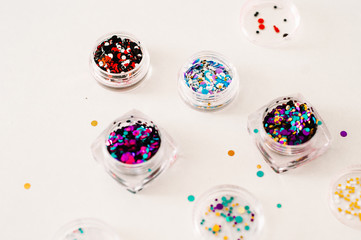 Nail designs on tips and manicure set on a colored background.