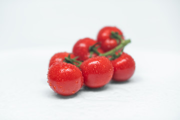 Closeup of fresh red tomato isolated on a gray background. Washed tomatoes on the table. Healthy lifestyle. Seasonal and summer vegetables