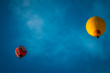 Two hot air balloons floating by in the sky