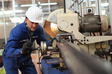 Fototapeta na wymiar Factory Engineer operating big machine cut off material for industry concept