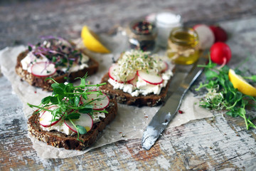 Selective focus. Healthy toasts with white cheese radish and microgreens. Cooking at home. Flat lay. Keto diet. Keto toasts. Organic food. Super food.