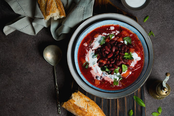 Traditional Ukrainian soup borscht with red beans and sour cream