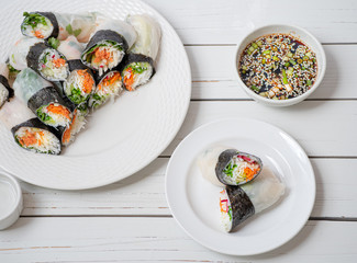 Vietnamese vegan rice paper and nori sheet spring rolls on white plate