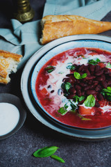Traditional Ukrainian soup borscht with red beans and sour cream