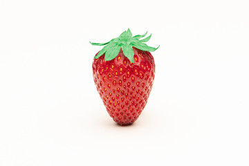 Red strawberry close up on a white surface
