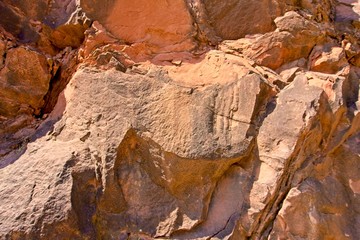 Stone texture and background. Rocky texture. Enormous face Aging and Divided by Huge Cracks and Layers. Thick, Rough Stone Texture Or Mountain Rock, Background And Thematic Geology And Mountain