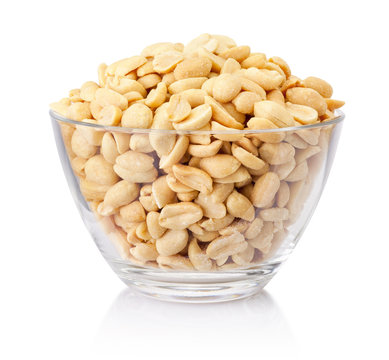 Roasted salted peanuts in glass bowl isolated on a white background