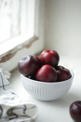on a light background a plate with a plum
