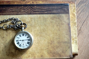 old pocket watch on the book