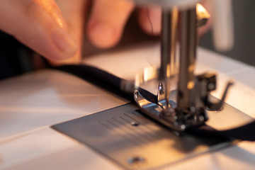Obraz na płótnie Canvas Sewing on a machine, home manufactory