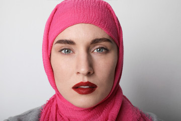 Close-up portrait of a muslim woman wearing a head scarf hijab and smilling. Isolated.