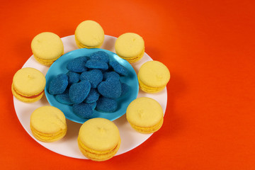 yellow biscuits and blue marmalade, on an orange background