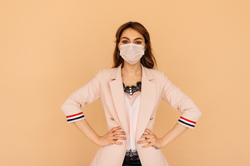 Young business woman with white medical mask isolated on yellow background