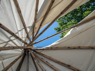 Blue sky peeking out from opening of teepee.
